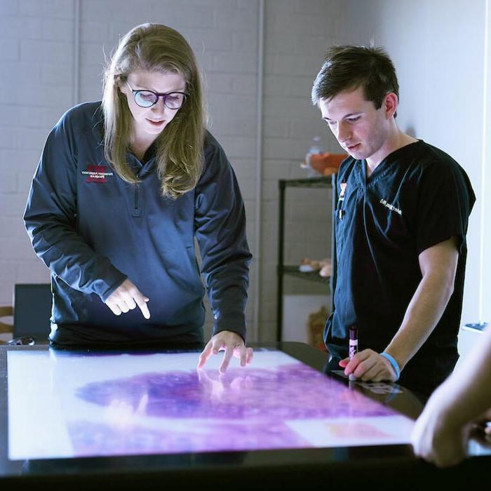 Students works with table-based tablet in classroom